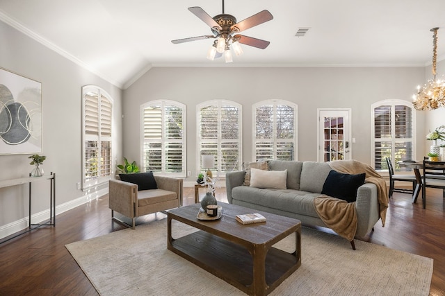 living room with lofted ceiling, ceiling fan with notable chandelier, dark wood-type flooring, and ornamental molding