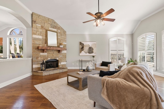 living room with dark hardwood / wood-style flooring, vaulted ceiling, ceiling fan, and a healthy amount of sunlight