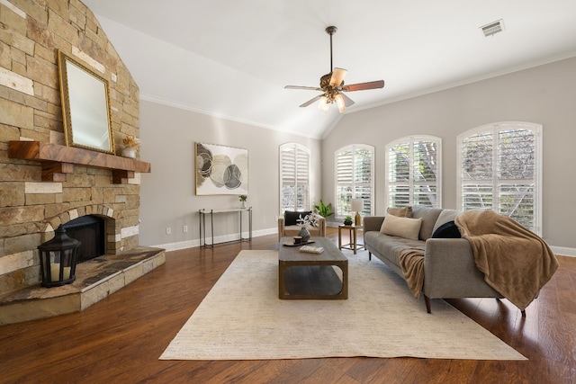 living room with ceiling fan, dark wood-type flooring, crown molding, and vaulted ceiling