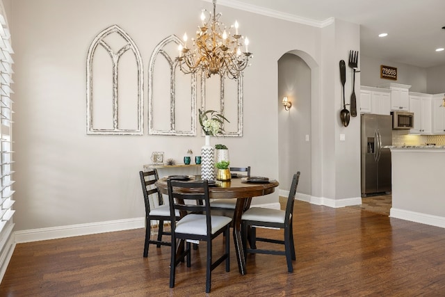 dining area with crown molding, a chandelier, and dark hardwood / wood-style floors