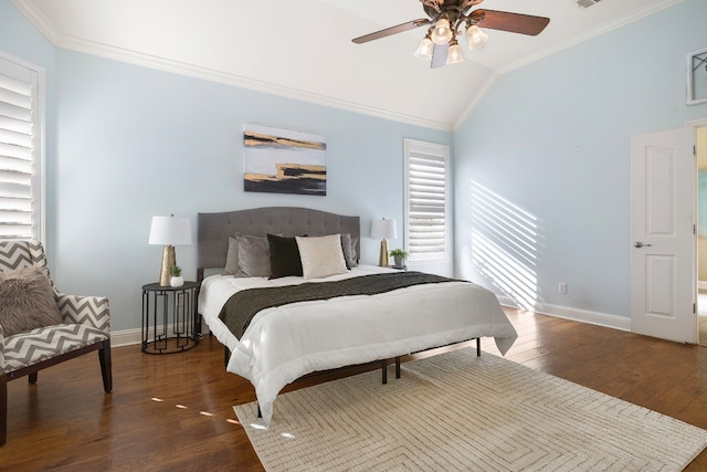 bedroom with ceiling fan, ornamental molding, dark wood-type flooring, and vaulted ceiling