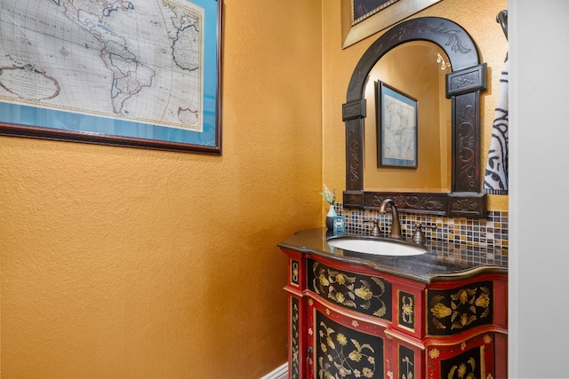 bathroom with decorative backsplash and vanity