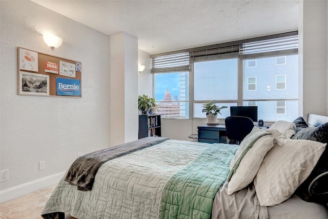 tiled bedroom with a textured ceiling