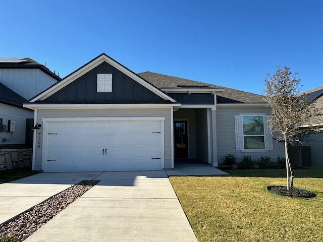 view of front facade with a garage and a front lawn