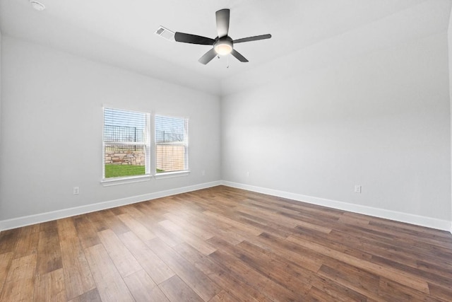 empty room with hardwood / wood-style floors and ceiling fan