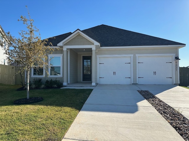 view of front of property with a front yard and a garage