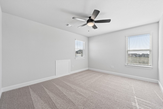 unfurnished room featuring ceiling fan and carpet