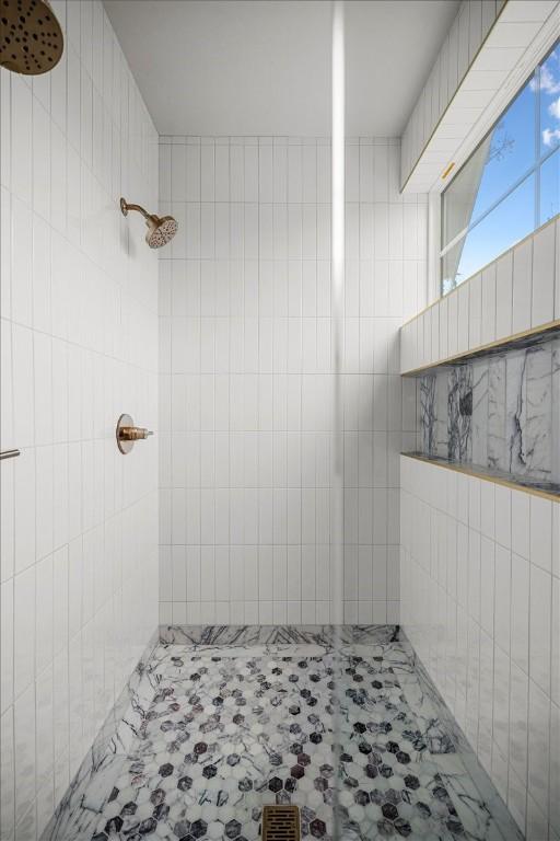 bathroom with tiled shower