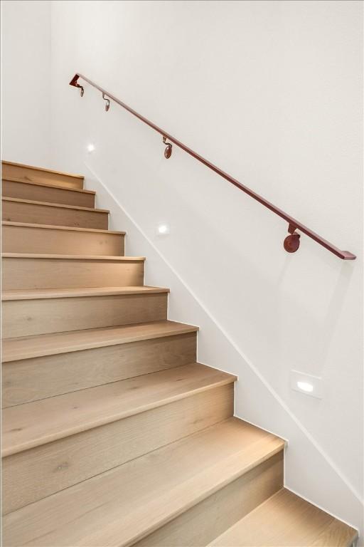 stairway featuring wood-type flooring