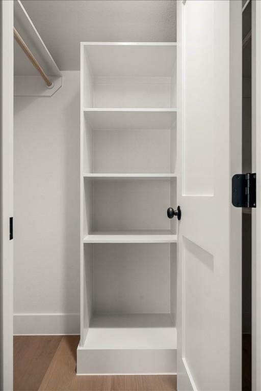 walk in closet featuring hardwood / wood-style floors