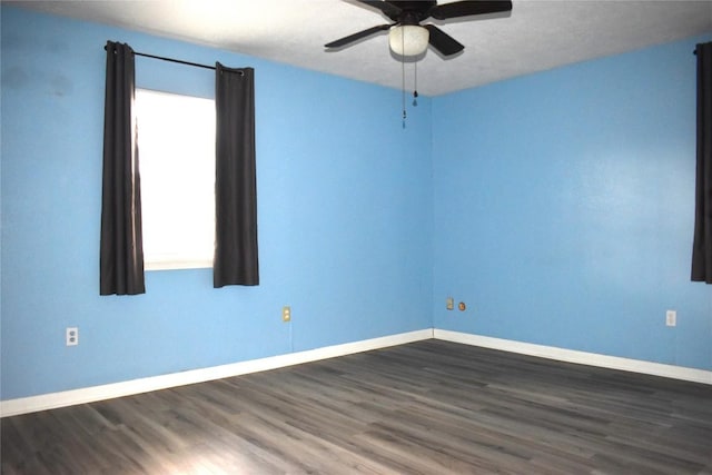 unfurnished room featuring ceiling fan and dark wood-type flooring