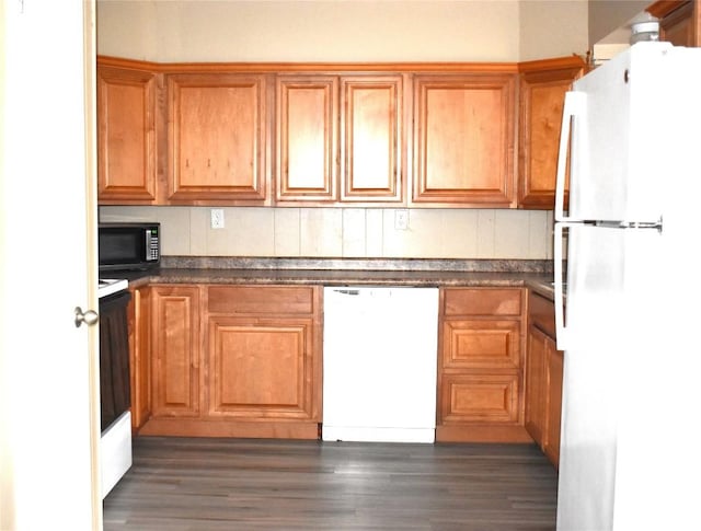 kitchen featuring dark hardwood / wood-style flooring and white appliances