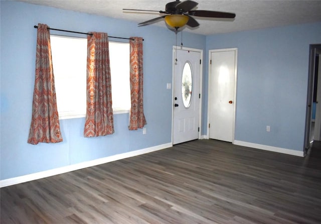 entryway featuring ceiling fan and dark wood-type flooring