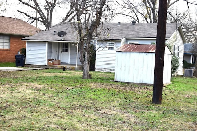 view of front of property with a front lawn and a storage shed