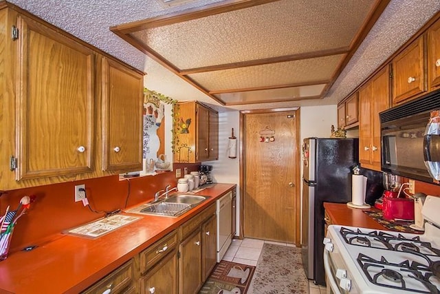 kitchen featuring white appliances, sink, and light tile patterned floors