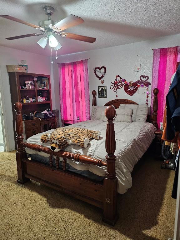 bedroom with carpet flooring, a textured ceiling, and ceiling fan