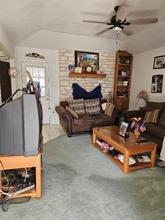 carpeted living room with vaulted ceiling and ceiling fan