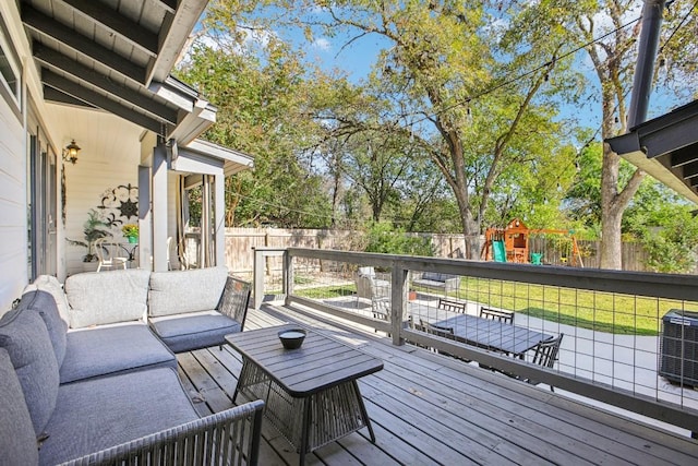 wooden terrace with a yard, an outdoor hangout area, a playground, and cooling unit