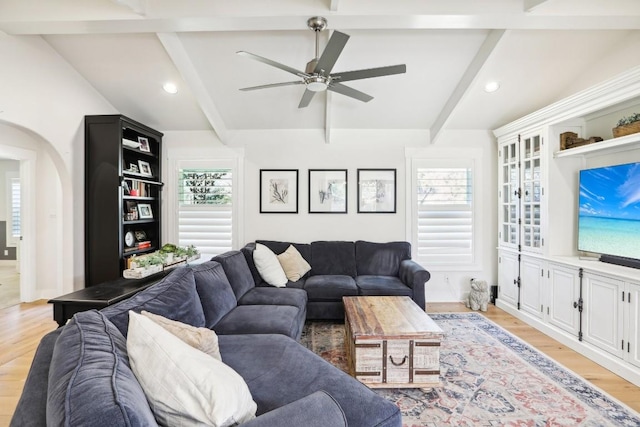 living room with beam ceiling, ceiling fan, and light hardwood / wood-style flooring