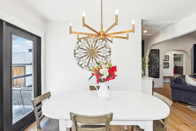 dining area featuring a notable chandelier and light wood-type flooring