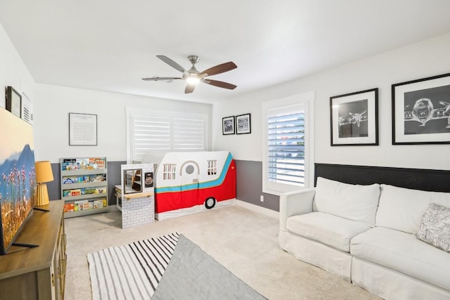 game room with ceiling fan and light colored carpet