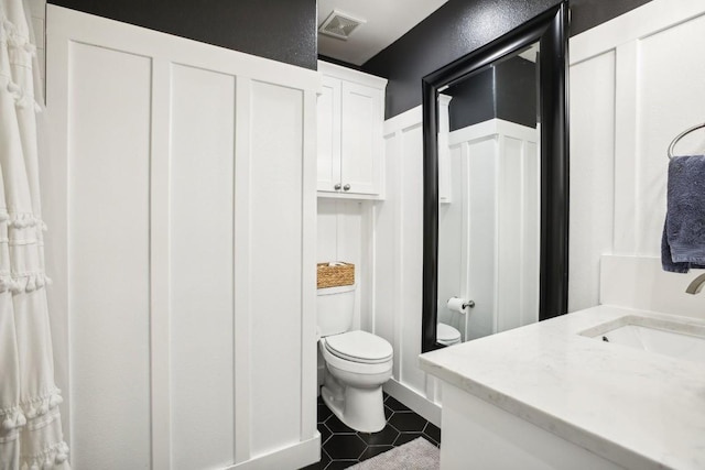 bathroom with tile patterned floors, vanity, and toilet