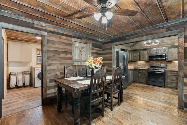 dining area featuring wooden ceiling, wooden walls, ceiling fan, light wood-type flooring, and washer / clothes dryer