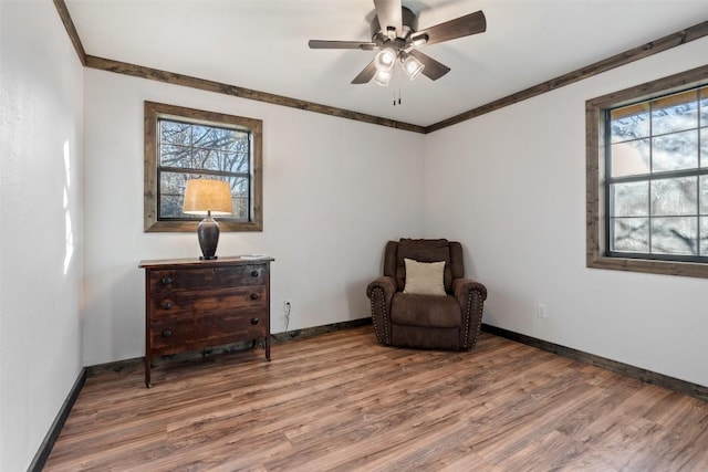 living area featuring hardwood / wood-style floors and ceiling fan