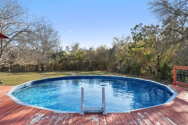 view of swimming pool with a wooden deck