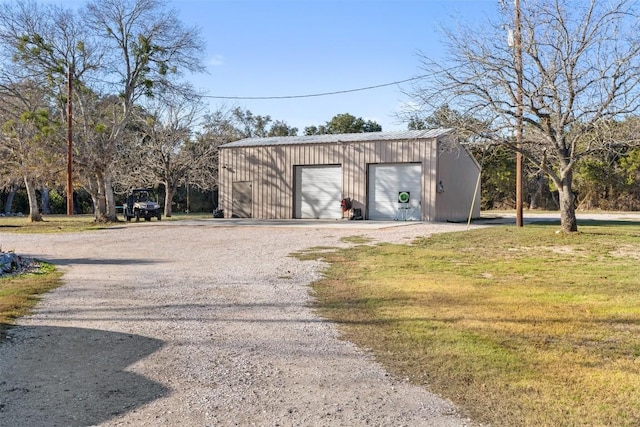 view of outdoor structure with a yard and a garage