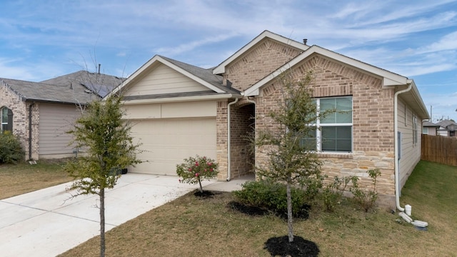 single story home with a garage, concrete driveway, fence, a front lawn, and brick siding