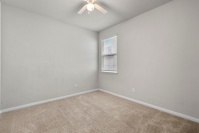 unfurnished room featuring carpet flooring, a ceiling fan, and baseboards