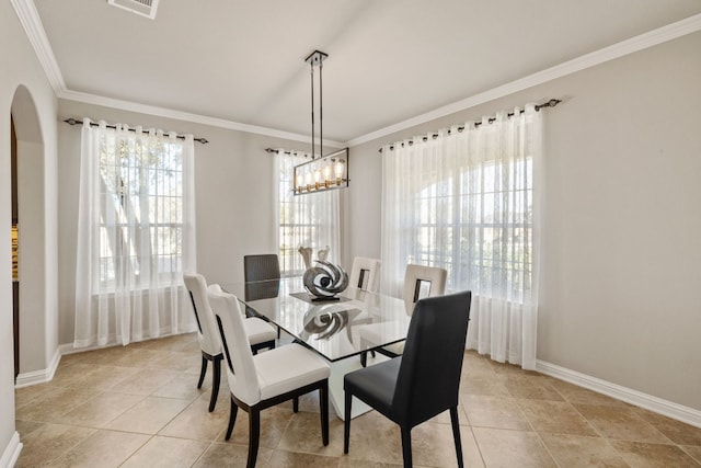 dining room with crown molding and light tile patterned flooring