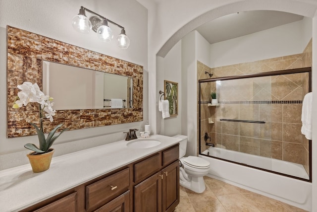 full bathroom featuring tile patterned flooring, vanity, bath / shower combo with glass door, and toilet