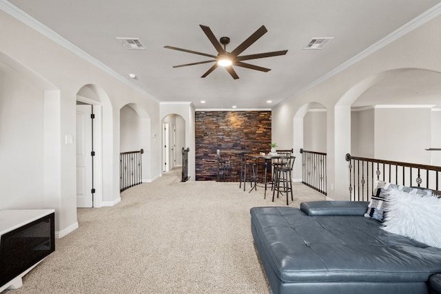 interior space with light carpet, ceiling fan, and crown molding