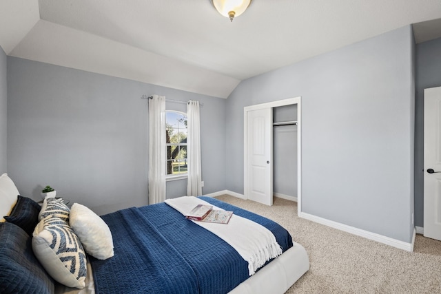 bedroom featuring carpet floors, a closet, and lofted ceiling