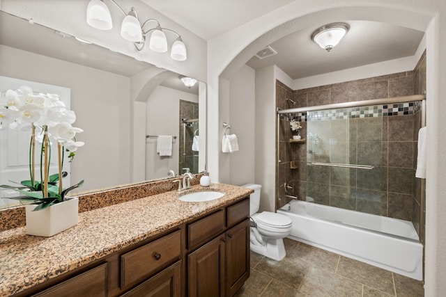 full bathroom with vanity, tiled shower / bath combo, and toilet