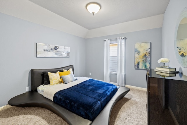 carpeted bedroom with vaulted ceiling