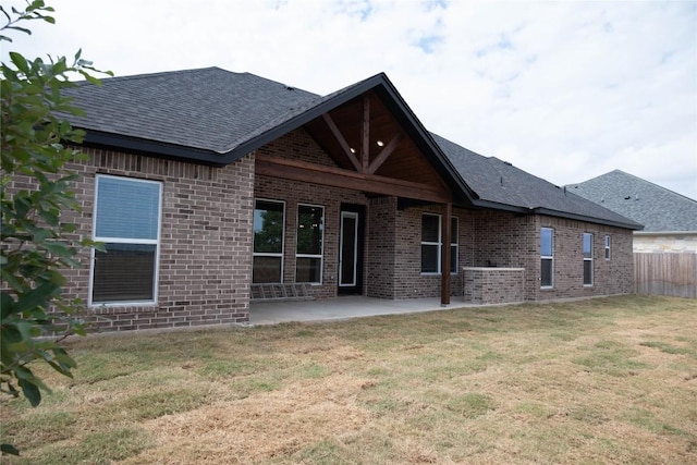 back of house featuring a lawn and a patio