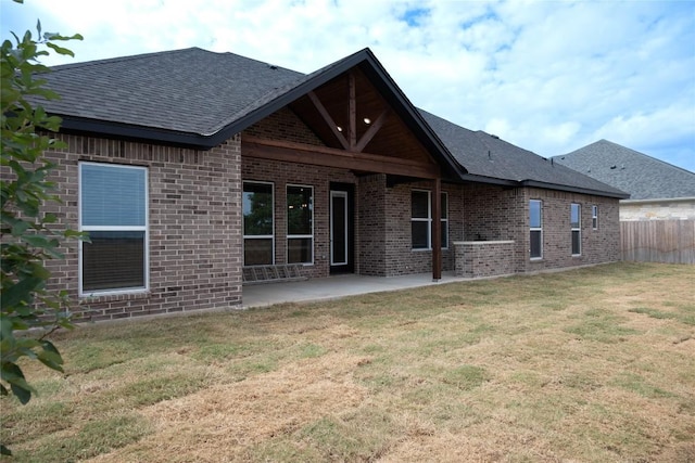 back of house featuring a patio area and a yard