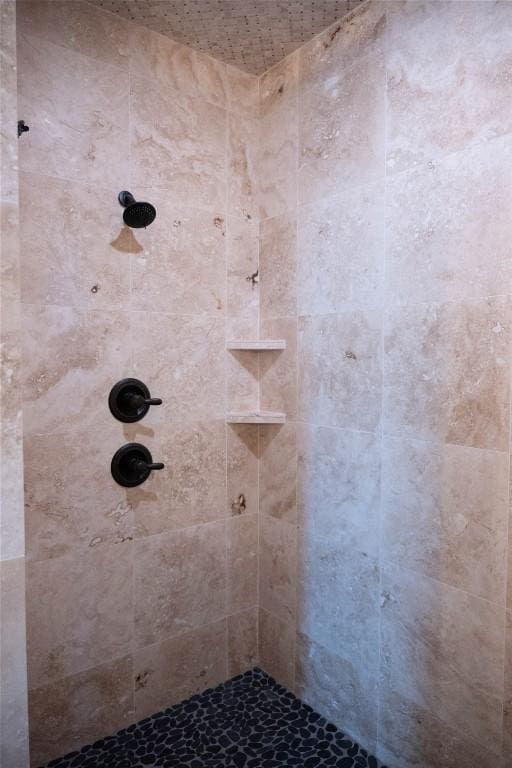 bathroom with a tile shower