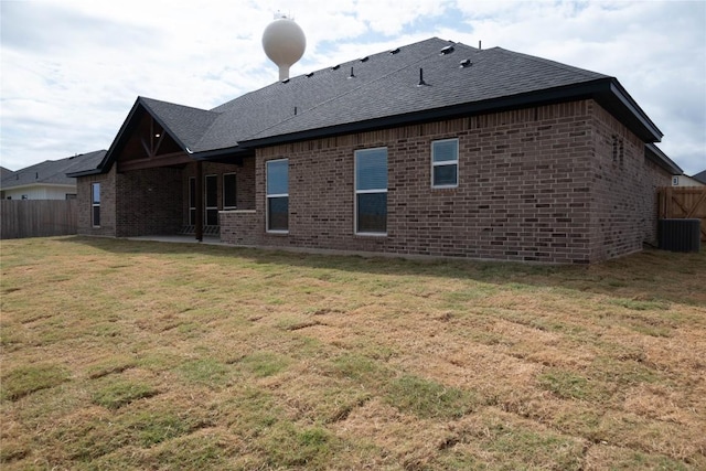 back of house with a lawn, a patio area, and central AC