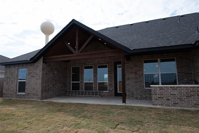 rear view of house with a patio area and a yard