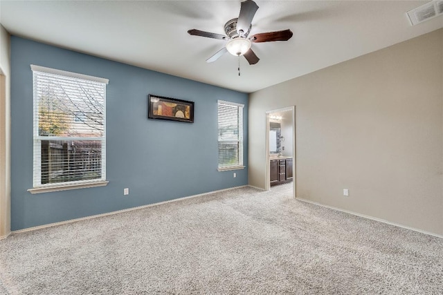 carpeted spare room with ceiling fan