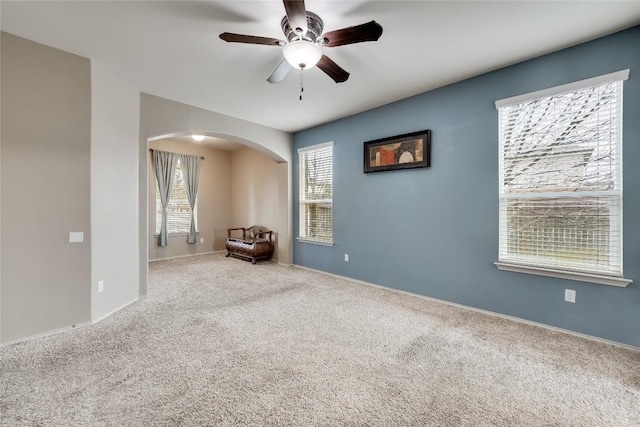 interior space featuring plenty of natural light, carpet floors, and ceiling fan