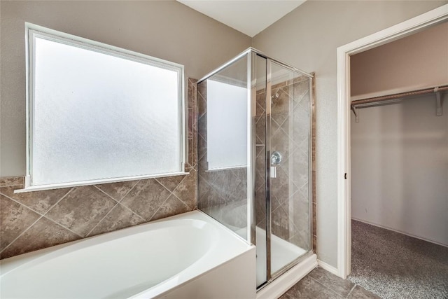 bathroom with tile patterned floors and plus walk in shower