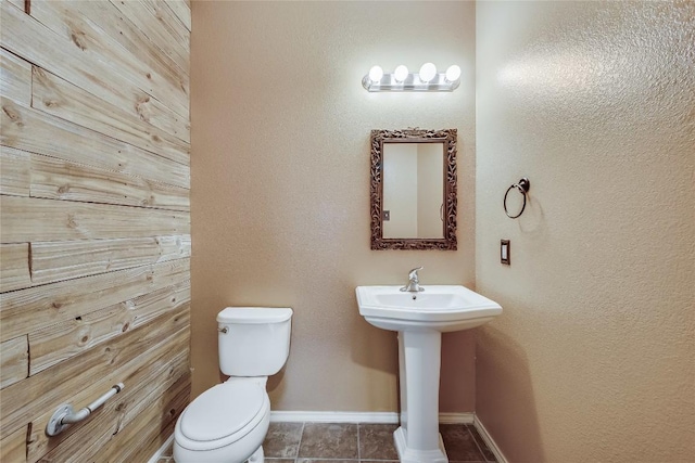 bathroom with tile patterned flooring and toilet