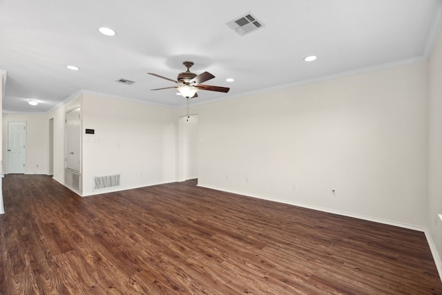 spare room featuring dark hardwood / wood-style floors, ceiling fan, and ornamental molding