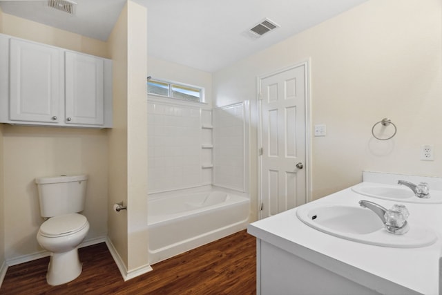 full bathroom featuring wood-type flooring, vanity, shower / bath combination, and toilet