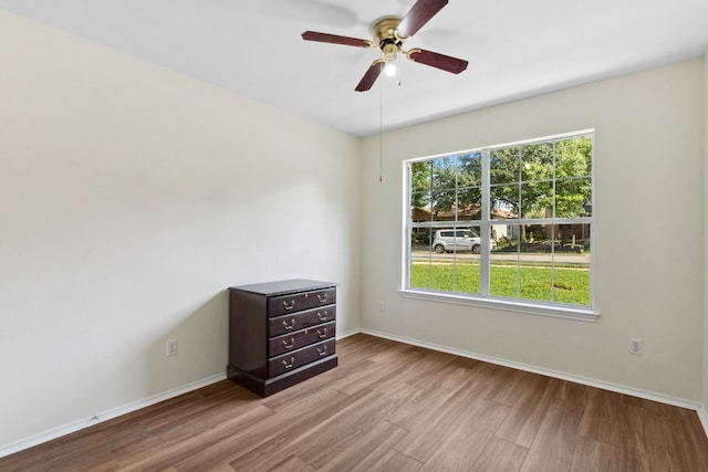 unfurnished room with ceiling fan, plenty of natural light, and light hardwood / wood-style floors